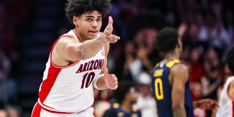 Arizona Wildcats forward Koa Peat holding out three fingers after making a three-point basket.