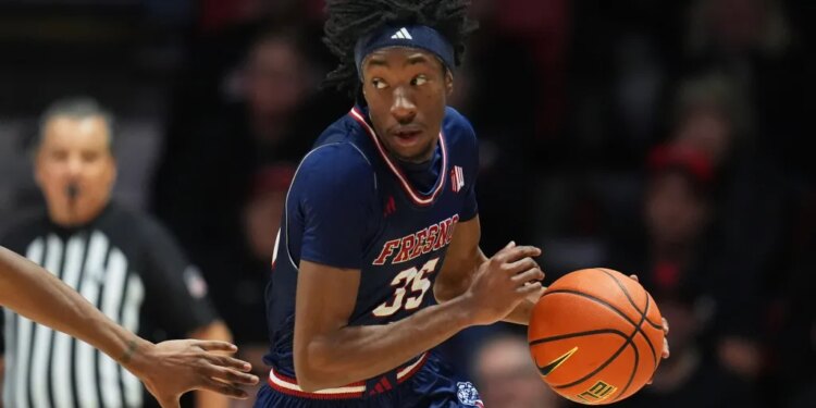 A Fresno State basketball player in a blue jersey with number 35 dribbles the ball.