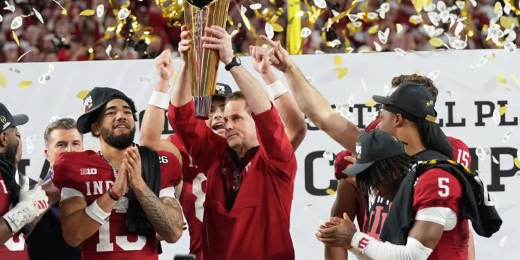 Indiana head coach Curt Cignetti holds the trophy after their win against Miami in the College Football Playoff national championship game, Monday, Jan. 19, 2026, in Miami Gardens, Fla.