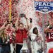 Indiana head coach Curt Cignetti holding up the Peach Bowl trophy after winning the game.