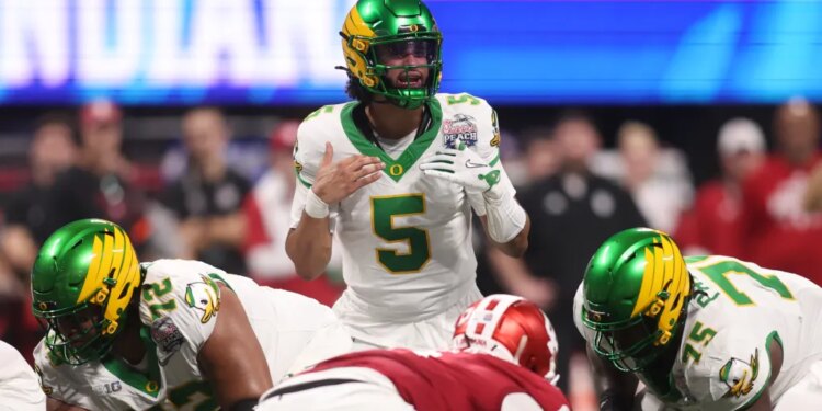 Oregon Ducks quarterback Dante Moore (5) calls a play on the line of scrimmage against the Indiana Hoosiers during the first quarter of the 2025 Peach Bowl and semifinal game of the College Football Playoff at Mercedes-Benz Stadium.