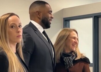 Kelli Moore, Sherrone Moore, and attorney Ellen Michaels at a court hearing.
