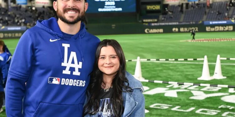 Alex Vesia and his wife Kayla posing on a baseball field.