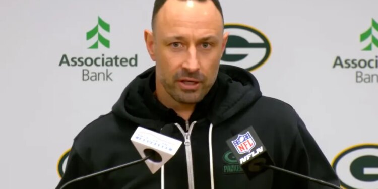 Jon-Eric Sullivan speaks into two microphones at a press conference.