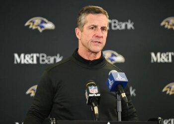 Baltimore Ravens head coach John Harbaugh speaking at a news conference.