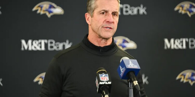 Baltimore Ravens head coach John Harbaugh speaking at a news conference.