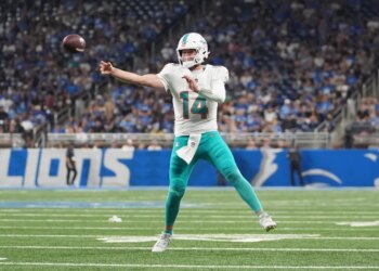 Miami Dolphins quarterback throwing a football.