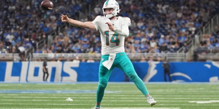 Miami Dolphins quarterback throwing a football.