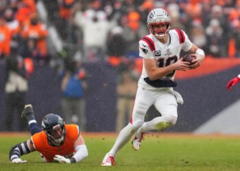 New England Patriots quarterback Drake Maye runs against the Denver Broncos during the second the half of the AFC Championship NFL football game, Sunday, Jan. 25, 2026, in Denver.