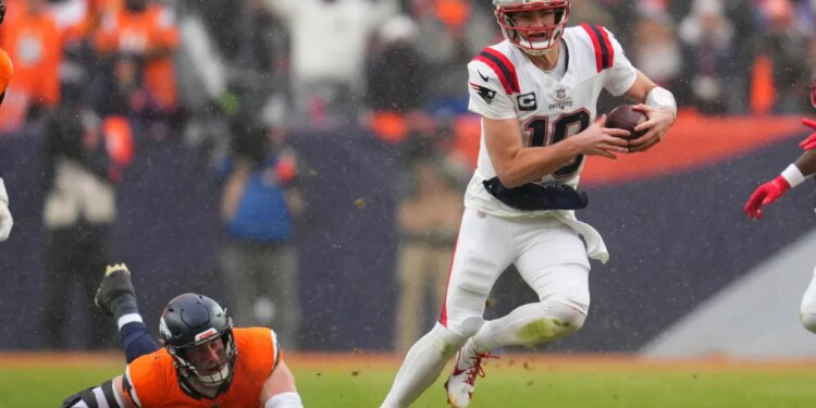 New England Patriots quarterback Drake Maye runs against the Denver Broncos during the second the half of the AFC Championship NFL football game, Sunday, Jan. 25, 2026, in Denver.