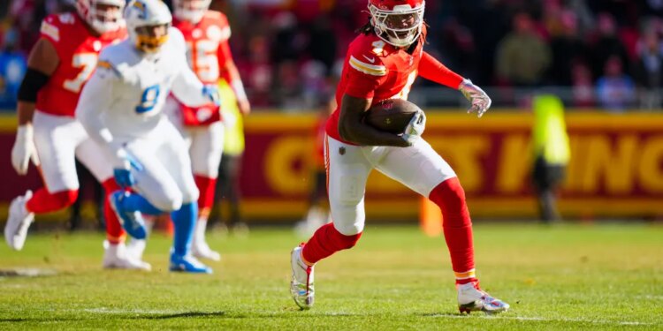 Kansas City Chiefs wide receiver Rashee Rice (4) runs for yards after the catch against the Los Angeles Chargers during the first quarter at GEHA Field at Arrowhead Stadium.