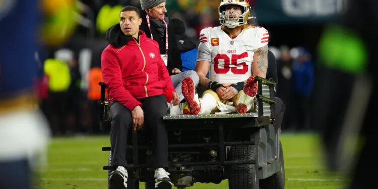 San Francisco 49ers tight end George Kittle (85) is carted off the field after an injury during an NFL playoff game.