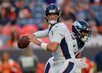 Denver Broncos quarterback Jarrett Stidham looks to pass.