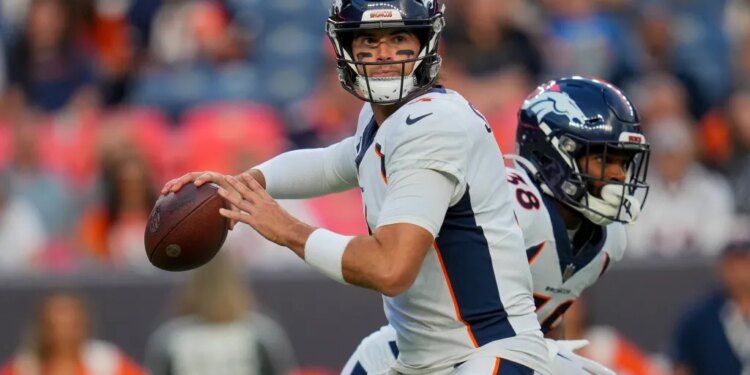 Denver Broncos quarterback Jarrett Stidham looks to pass.