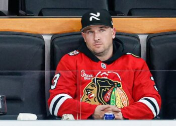 Alex Bregman watching an NHL game between the Chicago Blackhawks and Edmonton Oilers.