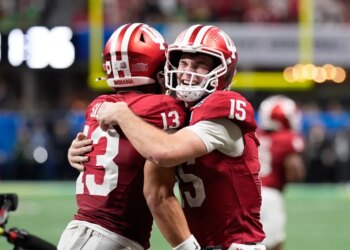 Indiana wide receiver Elijah Sarratt (13) celebrates his touchdown reception with quarterback Fernando Mendoza (15) during the second half of the Peach Bowl NCAA college football playoff semifinal, Friday, Jan. 9, 2026, in Atlanta.
