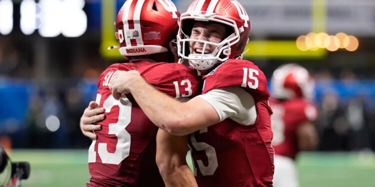 Indiana wide receiver Elijah Sarratt (13) celebrates his touchdown reception with quarterback Fernando Mendoza (15) during the second half of the Peach Bowl NCAA college football playoff semifinal, Friday, Jan. 9, 2026, in Atlanta.