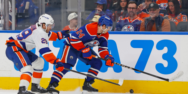 Jonathan Drouin (left) looks to take the puck away from Spencer Stastney during the second period of the Islanders' 1-0 road win over the Oilers on Jan. 15, 2026.