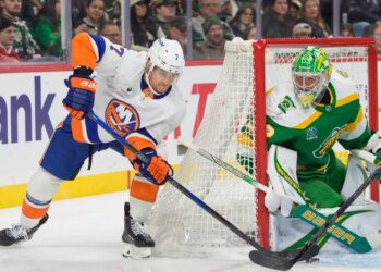 Maxim Tsyplakov (7) attempts a wraparound shot on Filip Gustavsson (32) during a hockey game.