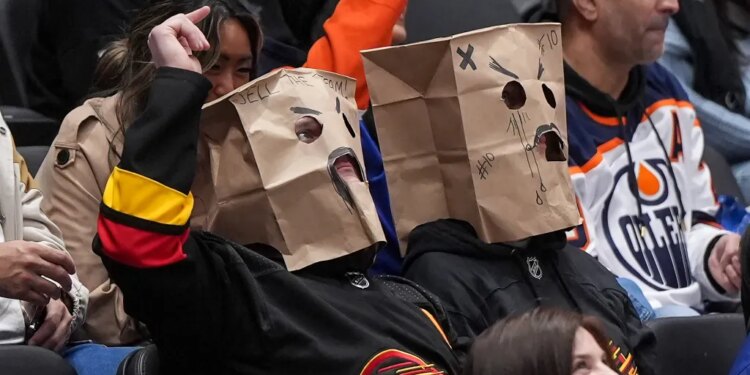 Vancouver Canucks fans wear paper bags on their heads during a 6-0 loss to the Edmonton Oilers.