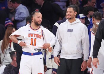 New York Knicks guard Jalen Brunson #11 speaks with New York Knicks guard Josh Hart #3 off the bench during the fourth quarter.