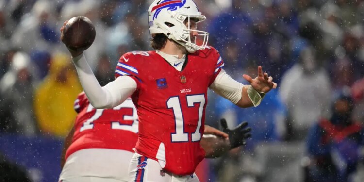 Buffalo Bills' Josh Allen throws the football during a game in the snow.