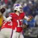 Buffalo Bills' Josh Allen throws the football during a game in the snow.