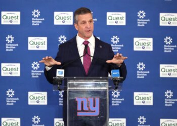 John Harbaugh speaking at a press conference as the new New York Giants head coach.