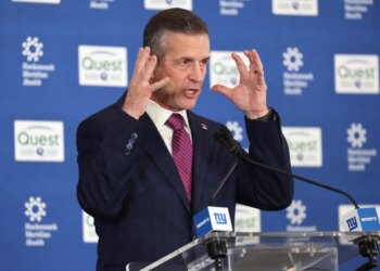 New New York Giants head coach John Harbaugh gestures while speaking at a press conference.