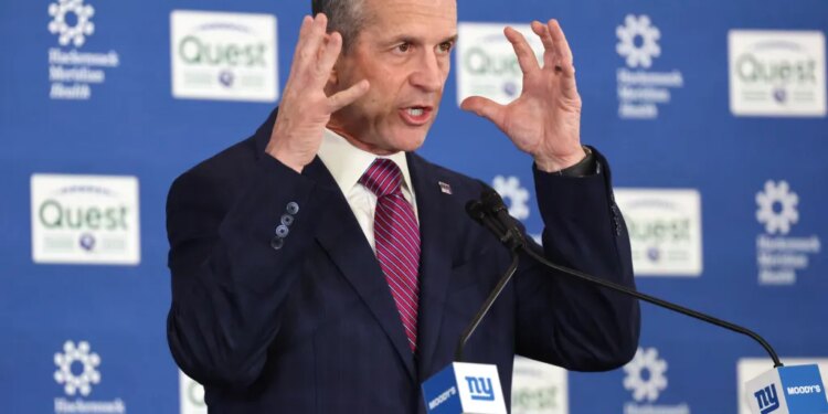 New New York Giants head coach John Harbaugh gestures while speaking at a press conference.