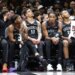 Terance Mann #14 of the Brooklyn Nets along with Michael Porter Jr. #17 of the Brooklyn Nets, Nic Claxton #33 of the Brooklyn Nets and Noah Clowney #21 of the Brooklyn Nets react on the bench during the fourth quarter.