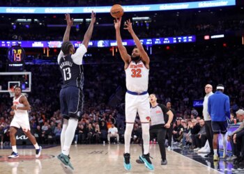 New York Knicks center Karl-Anthony Towns #32 puts up a shot as Dallas Mavericks forward Naji Marshall #13 defends during the third quarter.