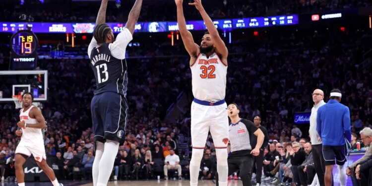 New York Knicks center Karl-Anthony Towns #32 puts up a shot as Dallas Mavericks forward Naji Marshall #13 defends during the third quarter.