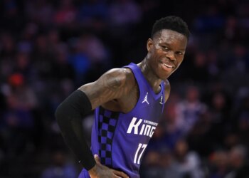 Sacramento Kings guard Dennis Schroder smiles between plays.