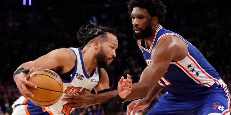 Jalen Brunson drives to the basket as Philadelphia 76ers center Joel Embiid defends in the second half at Madison Square Garden in Manhattan, New York, Saturday, January 03, 2026.