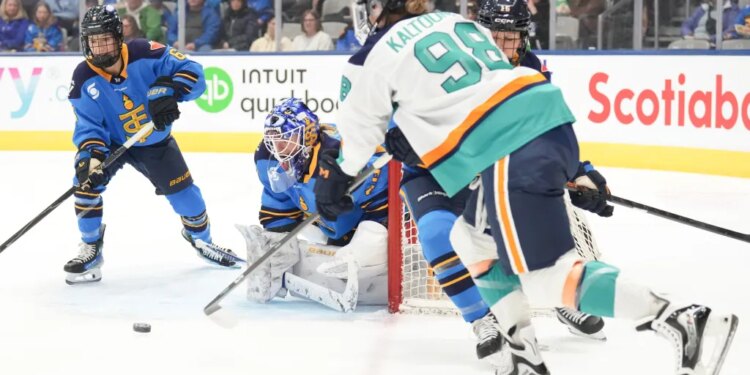 Kristyna Kaltounkova (98), who scored two goals, brings the puck around the net to shoot at goaltender Elaine Chuli, second left, during the first period of the Sirens' 2-0 win over the Sceptres on Jan. 6, 2025 in Toronto.