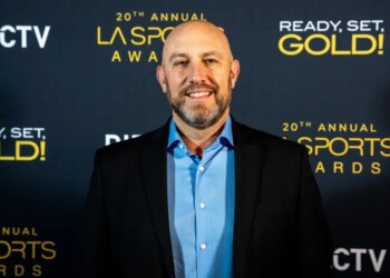 A man with a bald head and beard smiling at the 20th Annual LA Sports Awards.