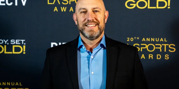 A man with a bald head and beard smiling at the 20th Annual LA Sports Awards.