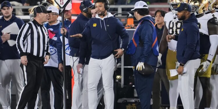 Notre Dame head coach Marcus Freeman gestures from the sideline during a game against Stanford.