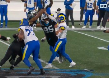 Matthew Stafford bends back a finger during a play against the Panthers in the Wild-Card matchup on Saturday evening.