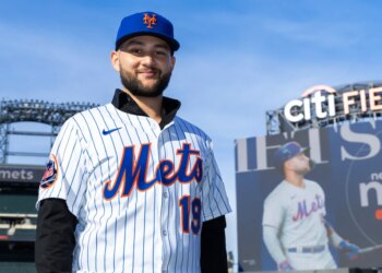 New York Mets infielder Bo Bichette poses on the field in his team uniform after his introductory press conference at Citi Field.