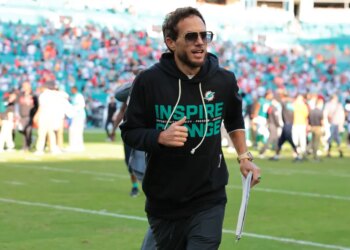 Miami Dolphins head coach Mike McDaniel runs off the field following a win over the Tampa Bay Buccaneers at Hard Rock Stadium.