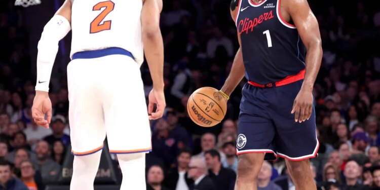 LA Clippers guard James Harden #1 looks for an opening as New York Knicks guard Miles McBride #2 defends during the third quarter.