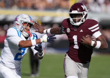 Mississippi State quarterback Kamario Taylor (1) stiff arms Mississippi cornerback Jaylon Braxton (2) as he runs for 22-yard touchdown during the first half of an NCAA college football game Nov. 28, 2025, in Starkville, Miss. (AP Photo/Rogelio V. Solis, File)