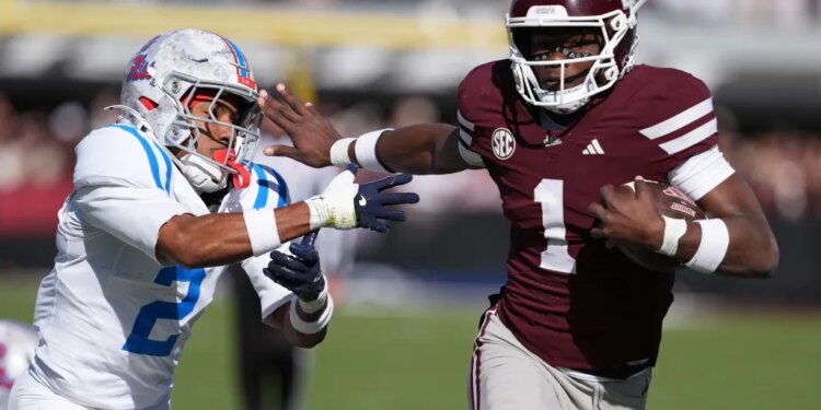Mississippi State quarterback Kamario Taylor (1) stiff arms Mississippi cornerback Jaylon Braxton (2) as he runs for 22-yard touchdown during the first half of an NCAA college football game Nov. 28, 2025, in Starkville, Miss. (AP Photo/Rogelio V. Solis, File)