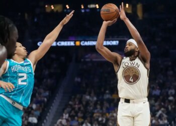 Golden State Warriors guard Moses Moody (4) shoots a 3-point basket against Charlotte Hornets forward Grant Williams (2) during the first half of an NBA basketball game in San Francisco, Saturday, Jan. 17, 2026.