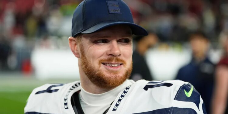 Seattle Seahawks quarterback Sam Darnold smiles.