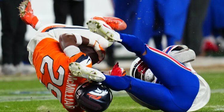 Broncos cornerback Ja'quan McMillian (29) intercepts a pass intended for Buffalo Bills wide receiver Brandin Cooks (18) during overtime of an NFL divisional round playoff football game, Saturday, Jan. 17, 2026, in Denver.