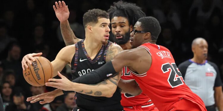 Jalen Smith #25 of the Chicago Bulls defends against Michael Porter Jr. #17 of the Brooklyn Nets as Porter Jr. looks for the open man during the second quarter.