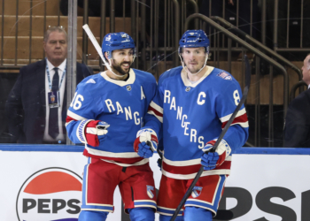 New York Rangers players Vincent Trocheck (16) and J.T. Miller (8) celebrate a goal.